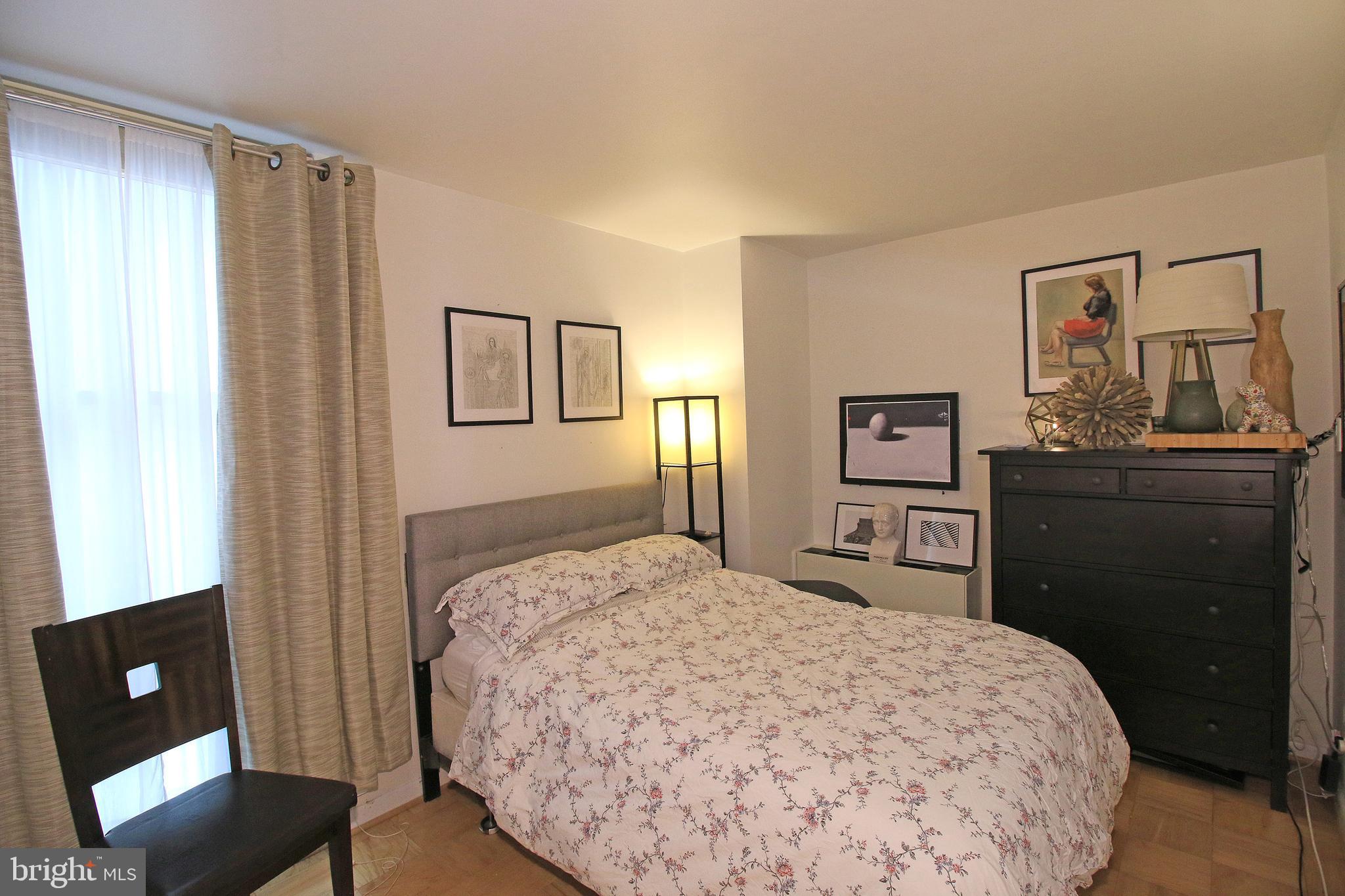 1260 21st Street Northwest, Unit 207 Washington, DC 20036 - Photo 6 of 16 a bedroom with a bed and a desk