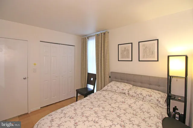 a bedroom with a bed and a dresser