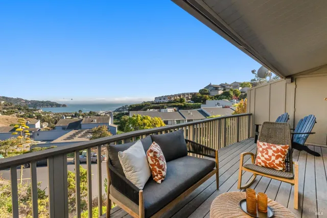 a view of a balcony with furniture
