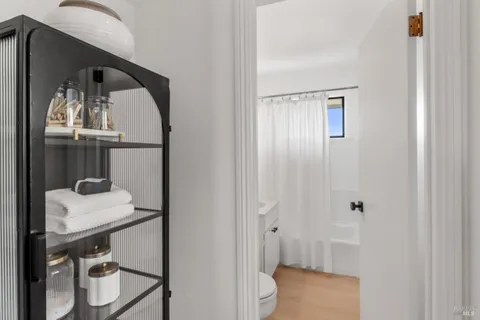 a bathroom with a sink a toilet and mirror