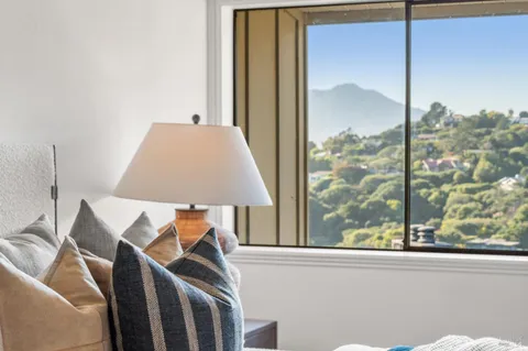 a view of a balcony with furniture and a window