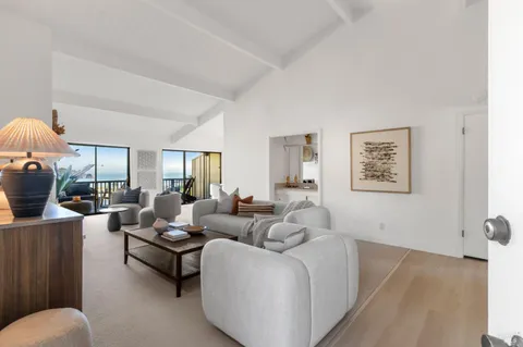 a living room with furniture and a lamp