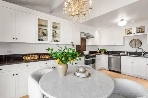 a kitchen with a white cabinets and white appliances