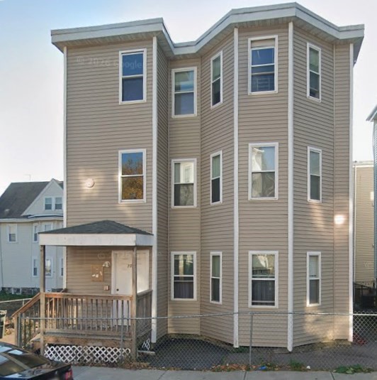a view of a brick house with large windows