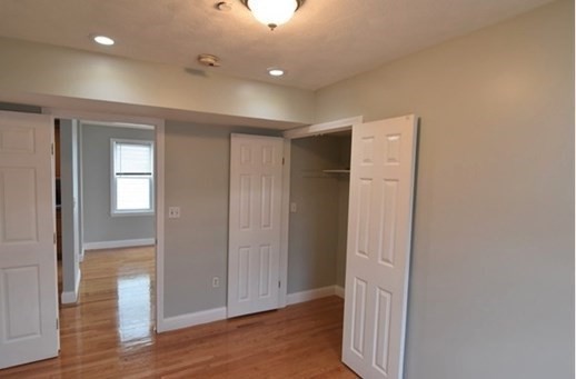 73 Hamilton Street Boston, MA 02125 - Photo 11 of 21 wooden floor in an empty room with a window