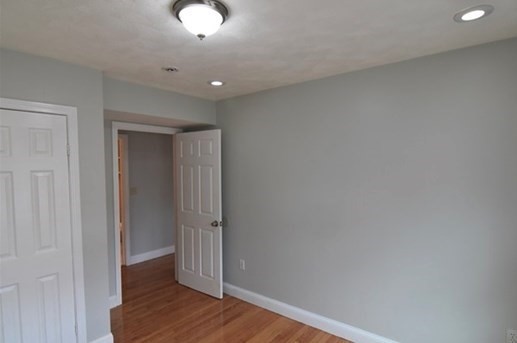 73 Hamilton Street Boston, MA 02125 - Photo 13 of 21 a view of a hallway with wooden floor