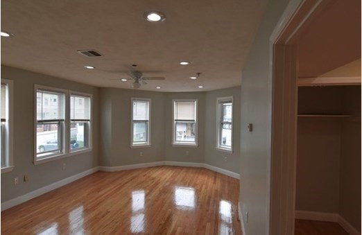 73 Hamilton Street Boston, MA 02125 - Photo 5 of 21 a view of empty room with wooden floor and fan