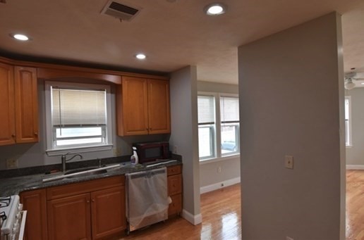 73 Hamilton Street Boston, MA 02125 - Photo 9 of 21 a kitchen with granite countertop sink cabinets and window