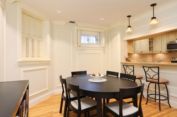 159 St Botolph Street, Unit 1 Boston, MA 02115 - Photo 2 of 8 a view of a dining room with furniture and wooden floor