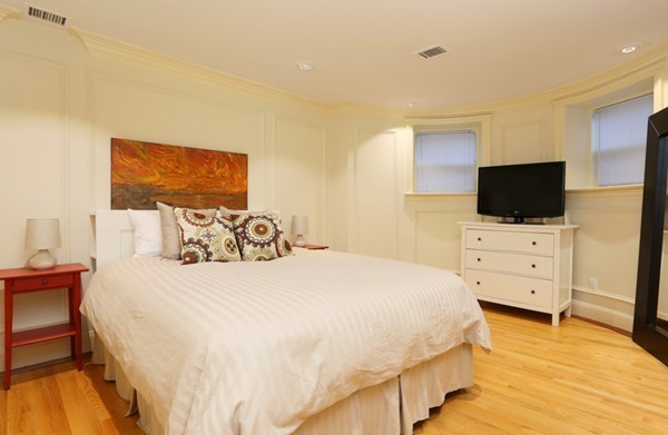 159 St Botolph Street, Unit 1 Boston, MA 02115 - Photo 5 of 8 a bedroom with a bed and flat screen tv