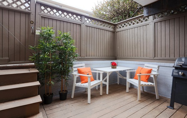 159 St Botolph Street, Unit 1 Boston, MA 02115 - Photo 7 of 8 an outdoor sitting area with furniture and wooden floor