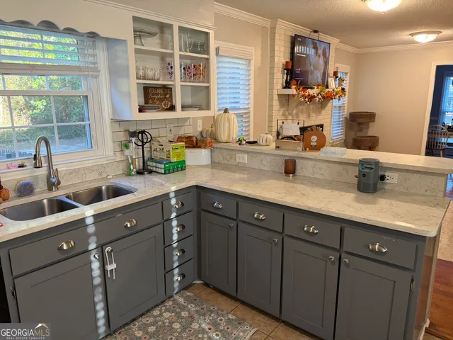 a kitchen with cabinets and window