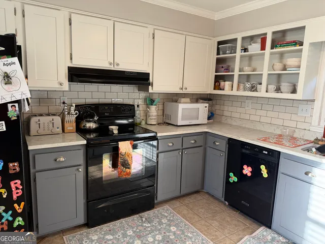 a kitchen with a stove and cabinets
