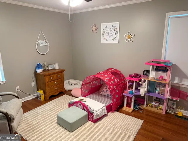 a bedroom with a bed and a dresser in it