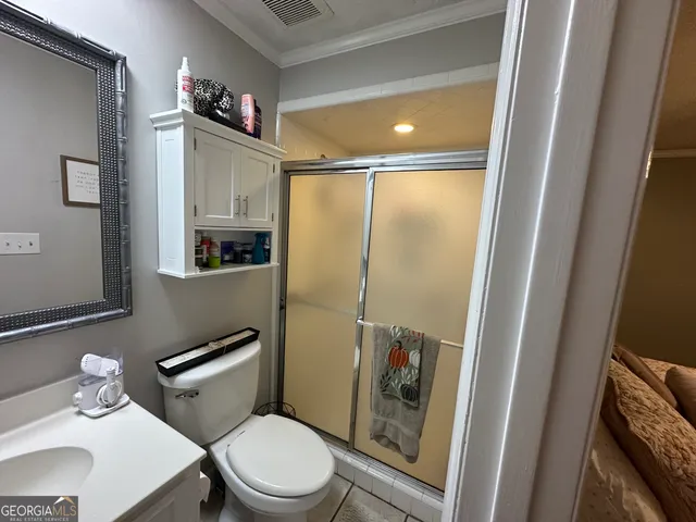 a white toilet sitting next to a bathroom sink