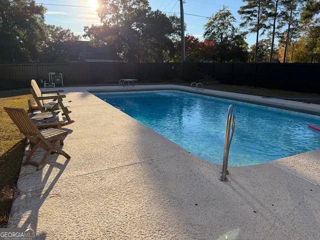 a view of swimming pool with lounge chair
