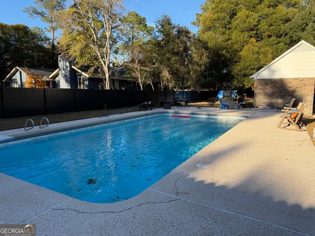 a view of a swimming pool with an outdoor seating