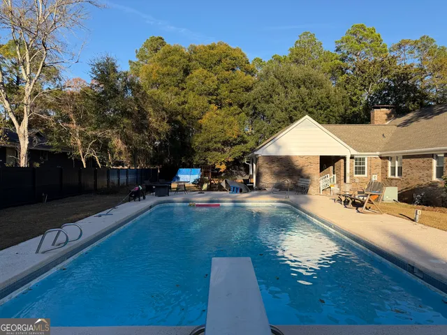 a view of a house with yard and sitting area