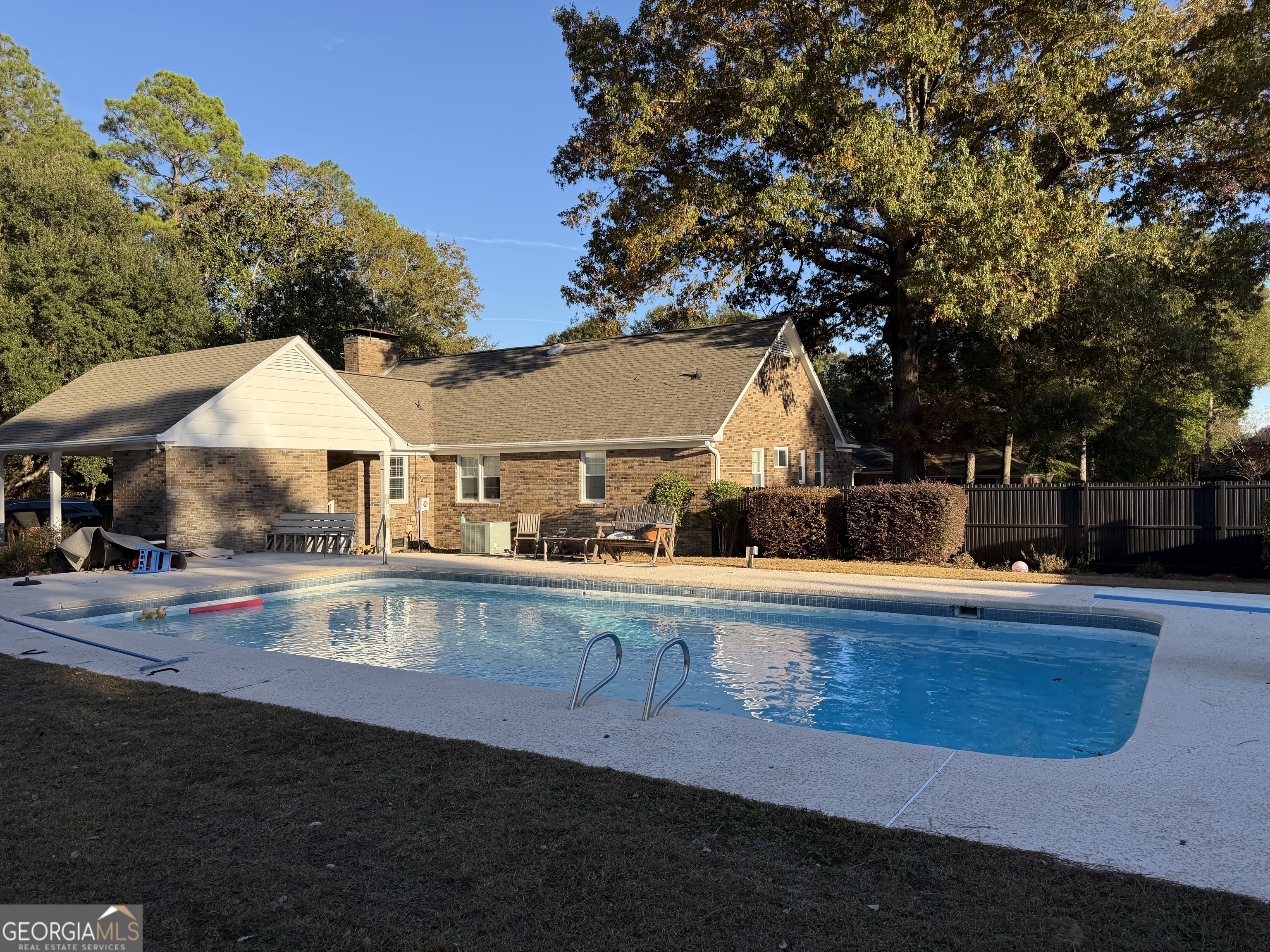 504 Payne Place Dublin, GA 31021 - Photo 8 of 22 a view of a house with pool and chairs
