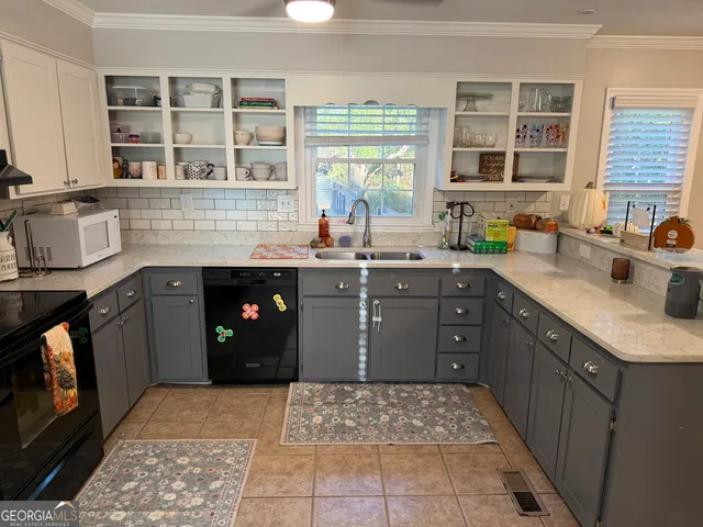 a kitchen with a sink stove and cabinets