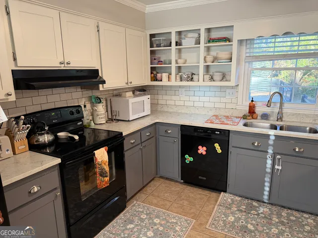 a kitchen with stainless steel appliances granite countertop a sink stove and cabinets