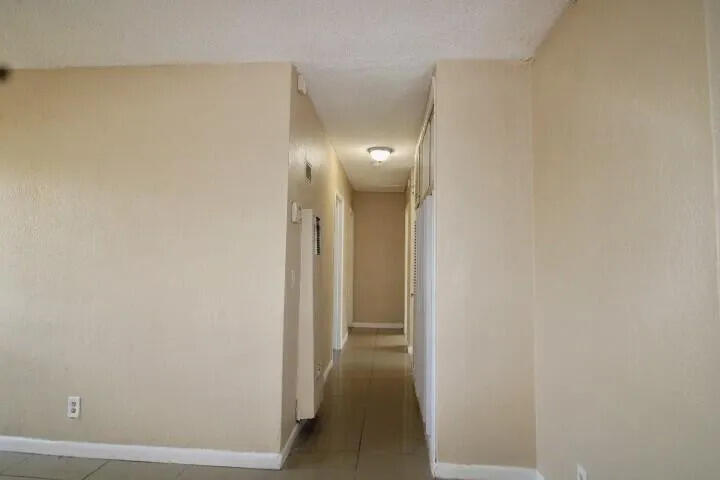 1205 West 24th Street Riviera Beach, FL 33404 - Photo 9 of 11 a view of a hallway with wooden floor