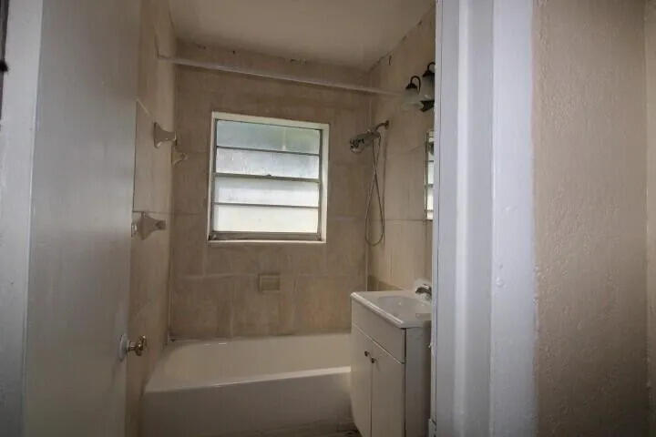 1205 West 24th Street Riviera Beach, FL 33404 - Photo 10 of 11 a bathroom with a bathtub