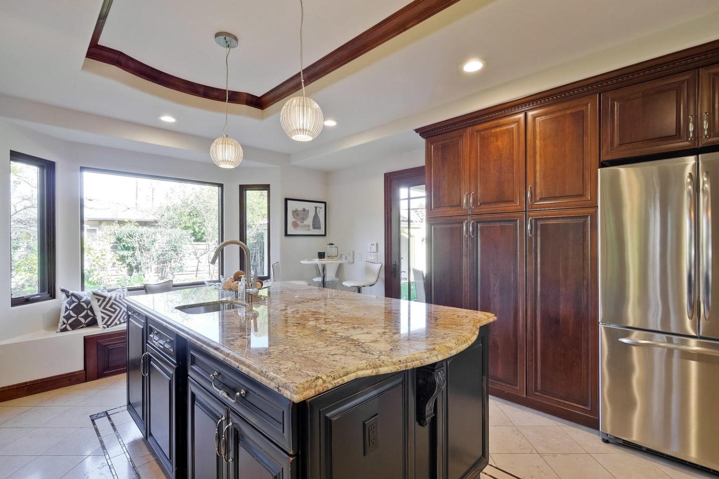 1725 Newell Road Palo Alto, CA 94303 - Photo 16 of 47 a kitchen with stainless steel appliances granite countertop a sink a refrigerator and wooden cabinets