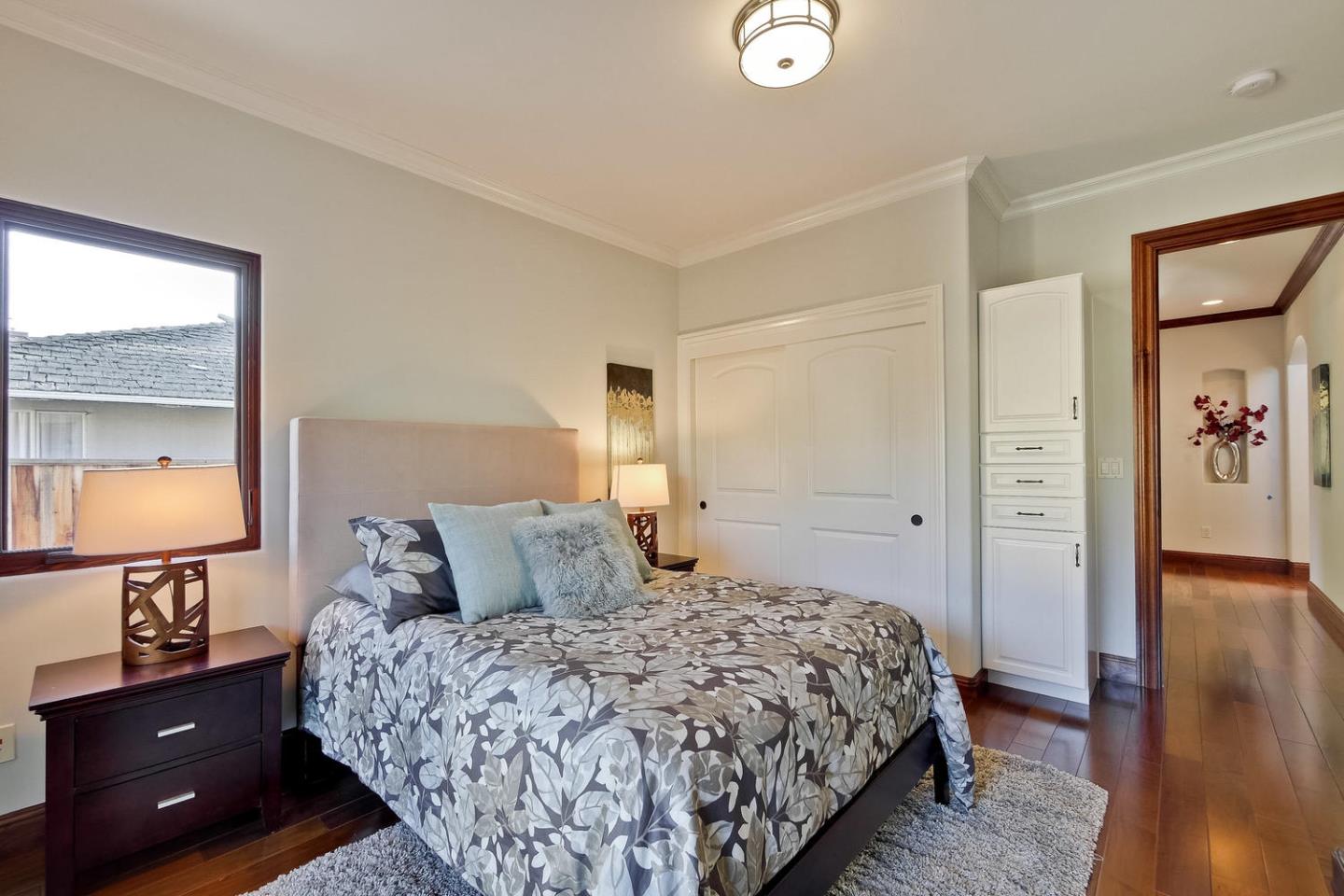 1725 Newell Road Palo Alto, CA 94303 - Photo 27 of 47 a bedroom with a bed and a lamp on dresser