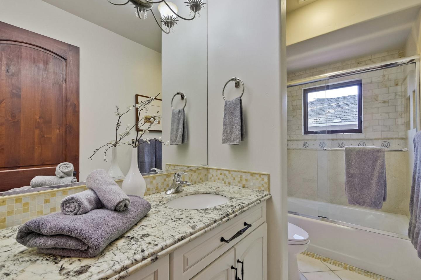 1725 Newell Road Palo Alto, CA 94303 - Photo 34 of 47 a bathroom with a granite countertop sink and a mirror