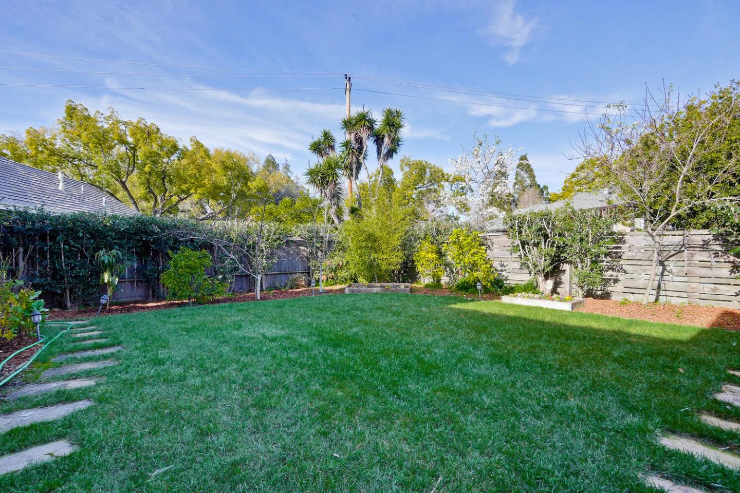 1725 Newell Road Palo Alto, CA 94303 - Photo 43 of 47 a view of a garden with a building in the background