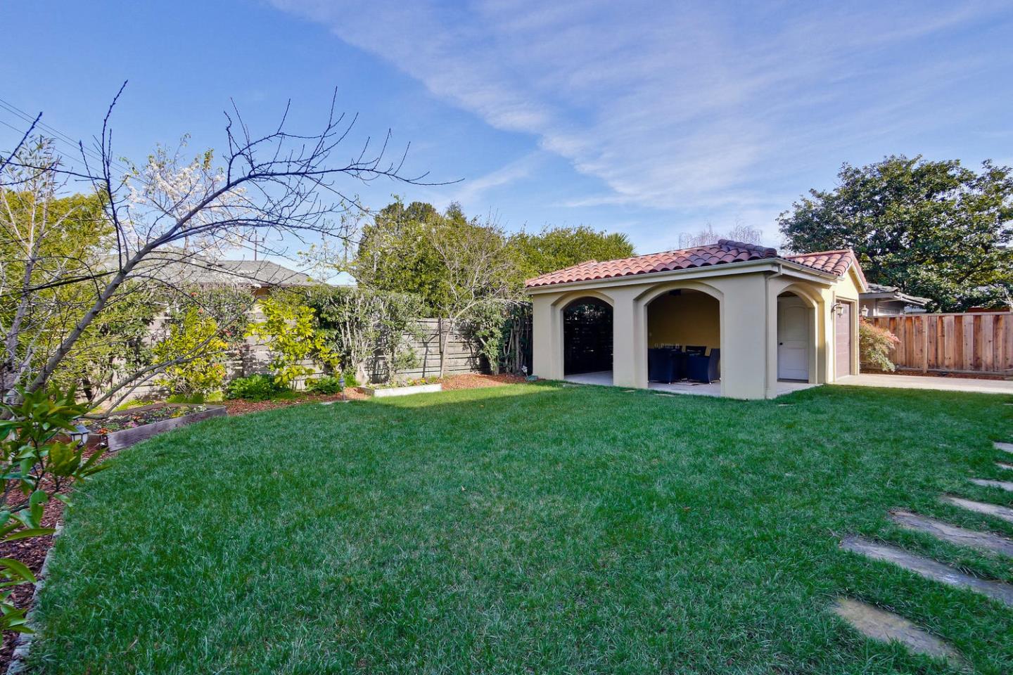 1725 Newell Road Palo Alto, CA 94303 - Photo 45 of 47 a view of a white house with a big yard and potted plants