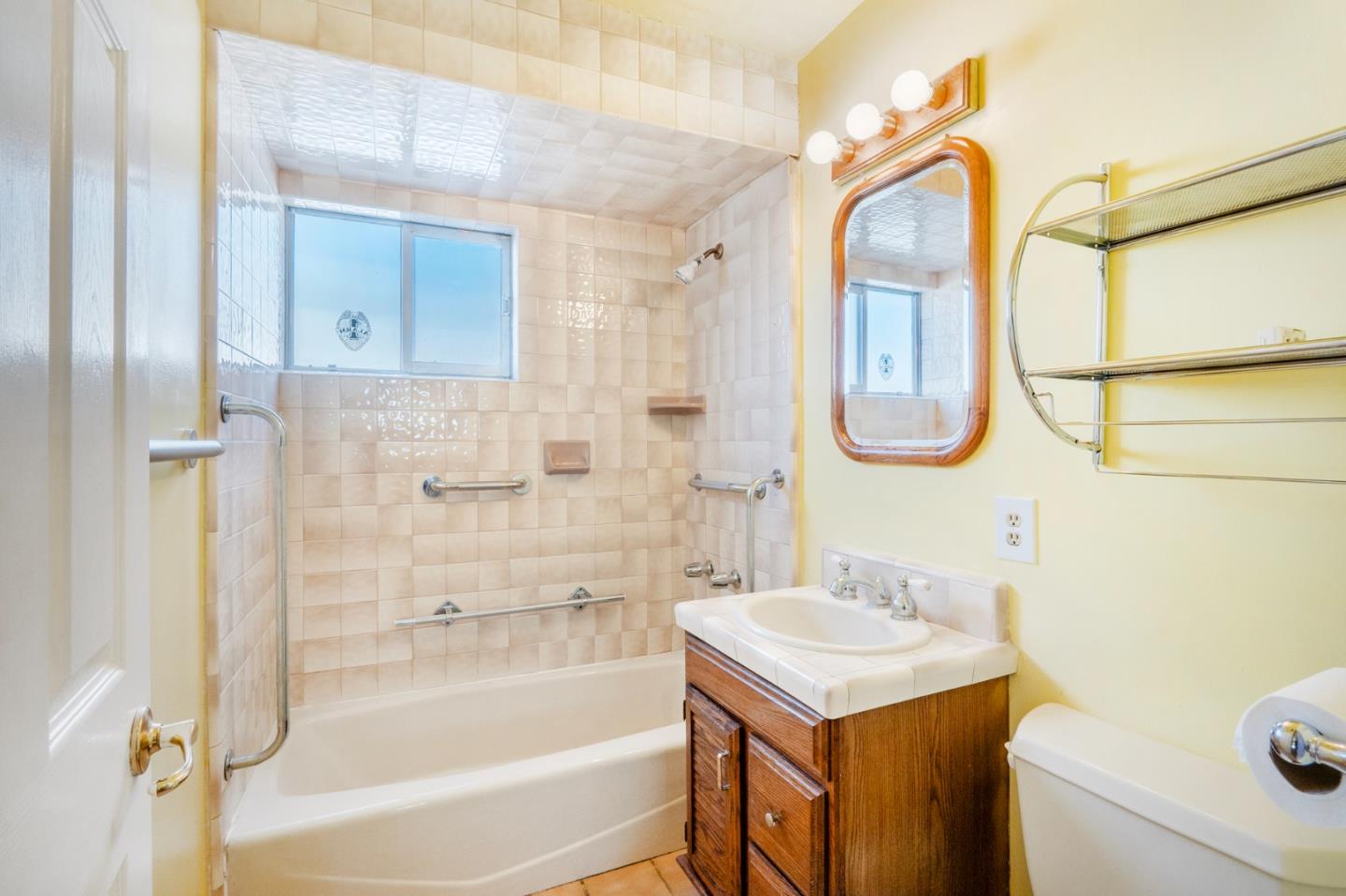 421 Fairview Drive Gilroy, CA 95020 - Photo 19 of 23 a bathroom with a sink vanity mirror and shower