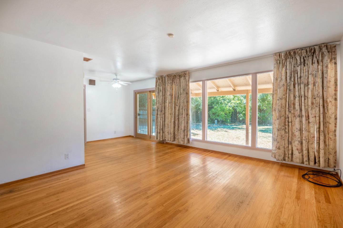 421 Fairview Drive Gilroy, CA 95020 - Photo 5 of 23 a view of an empty room with wooden floor and a window