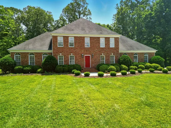 a front view of house with yard and green space