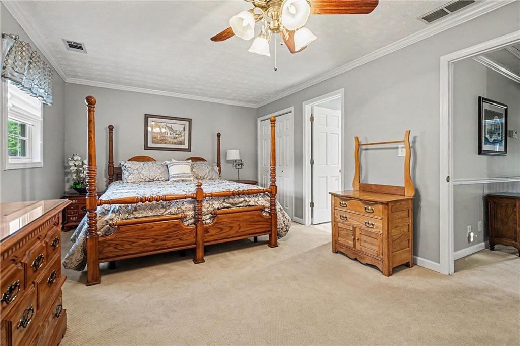 740 Smyrna Road Southwest Conyers, GA 30094 - Photo 13 of 27 a bedroom with a bed dresser and a window