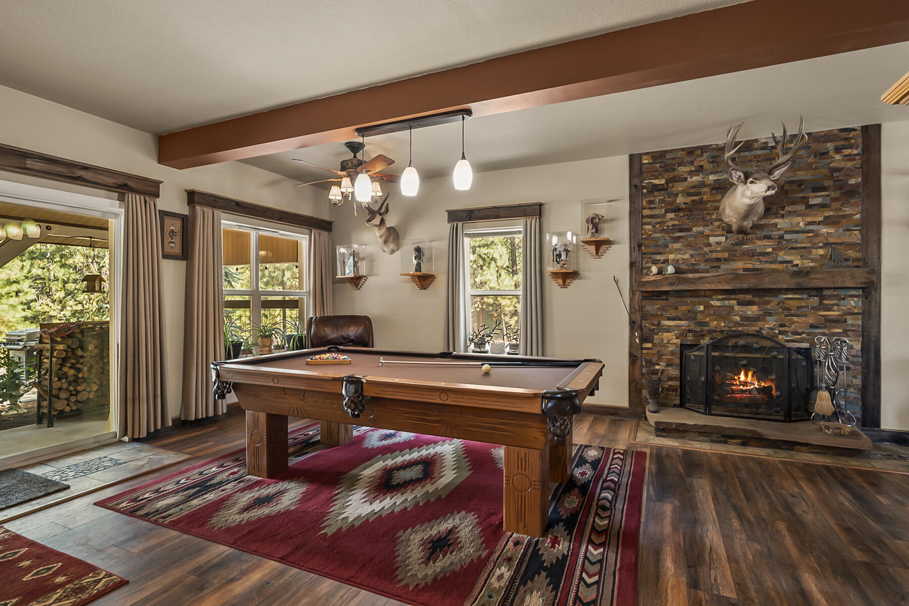 15730 Jackpine Road La Pine, OR 97739 - Photo 9 of 43 a living room with furniture a fireplace and a large window