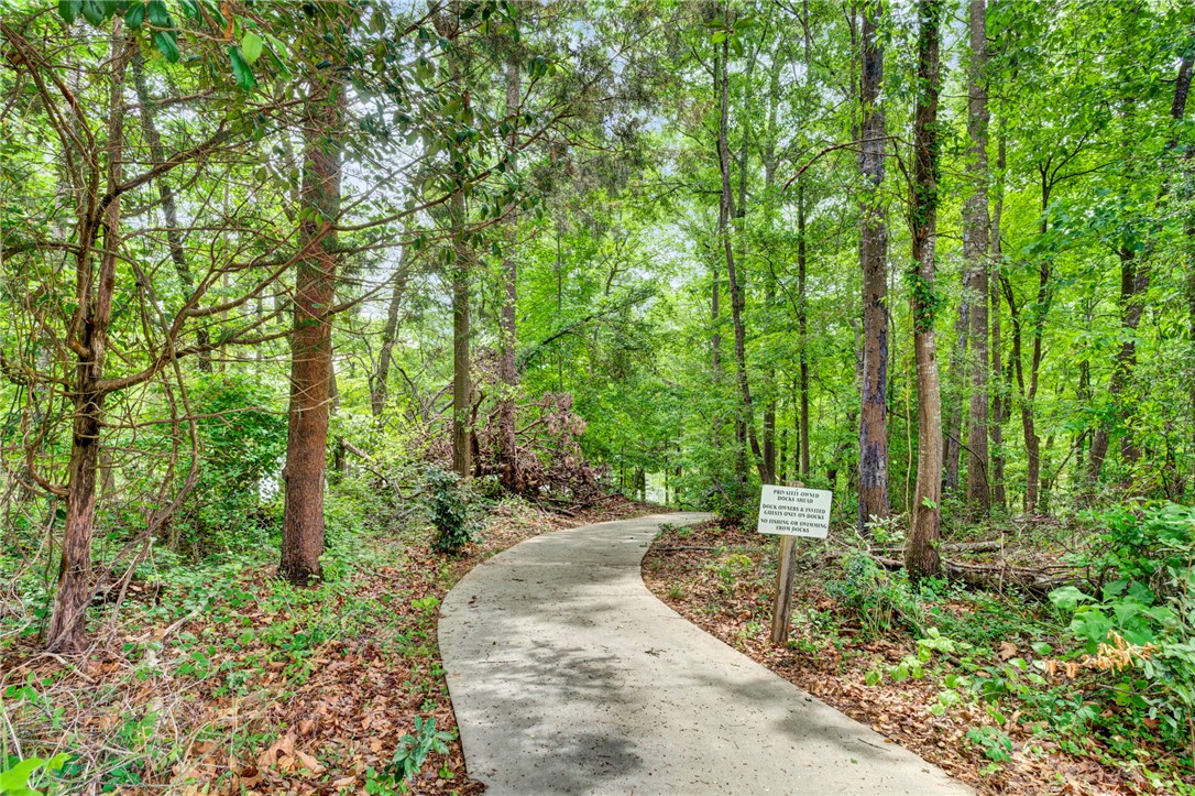 104 Captains Way Anderson, SC 29625 - Photo 46 of 47 A tranquil path winds through lush greenery, offering a serene escape into nature's embrace.