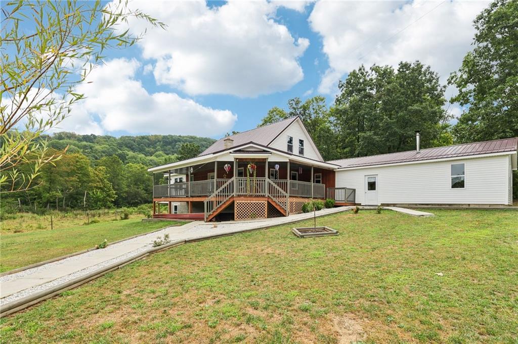 1056 Dora Road Punxsutawney, PA 15767 - Photo 11 of 50 a white house with a big yard and large trees