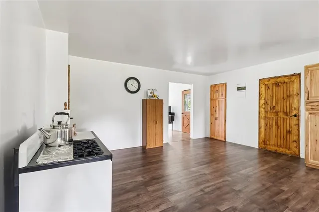 a kitchen with granite countertop a stove and a refrigerator