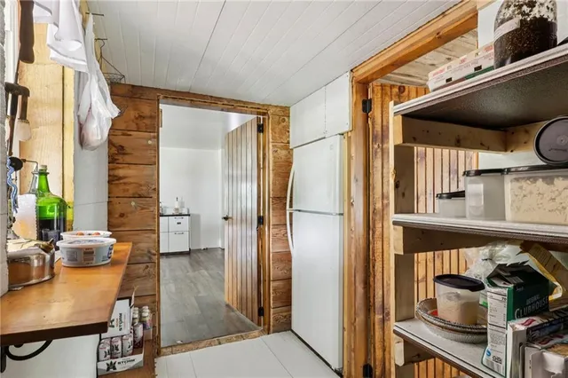 a view of a hallway with wooden floor and windows