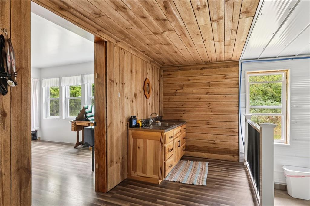 1056 Dora Road Punxsutawney, PA 15767 - Photo 38 of 50 a view of a hallway with wooden floor and windows