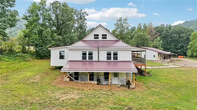 a aerial view of a house with a yard balcony and swimming pool