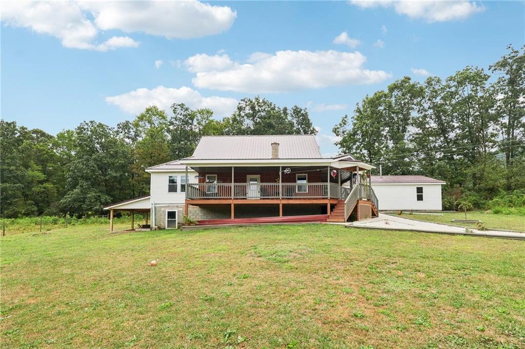 1056 Dora Road Punxsutawney, PA 15767 - Photo 8 of 50 a view of a house with a big yard and large trees