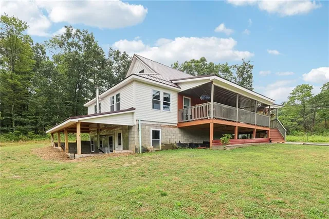 a front view of a house with a yard and balcony