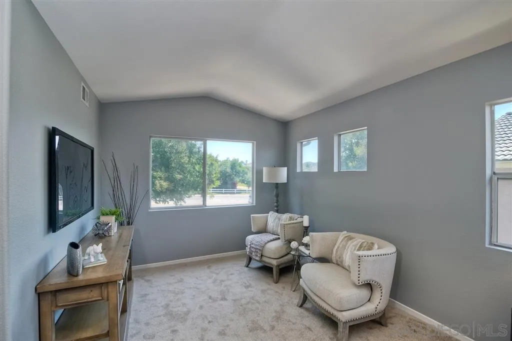 11574 Village Ridge Road San Diego, CA 92131 - Photo 15 of 25 a living room with furniture and a flat screen tv