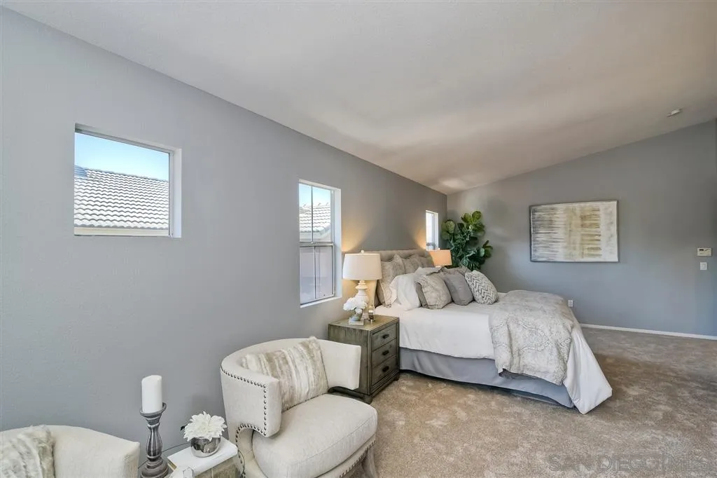 11574 Village Ridge Road San Diego, CA 92131 - Photo 16 of 25 a bedroom with a bed and a couch