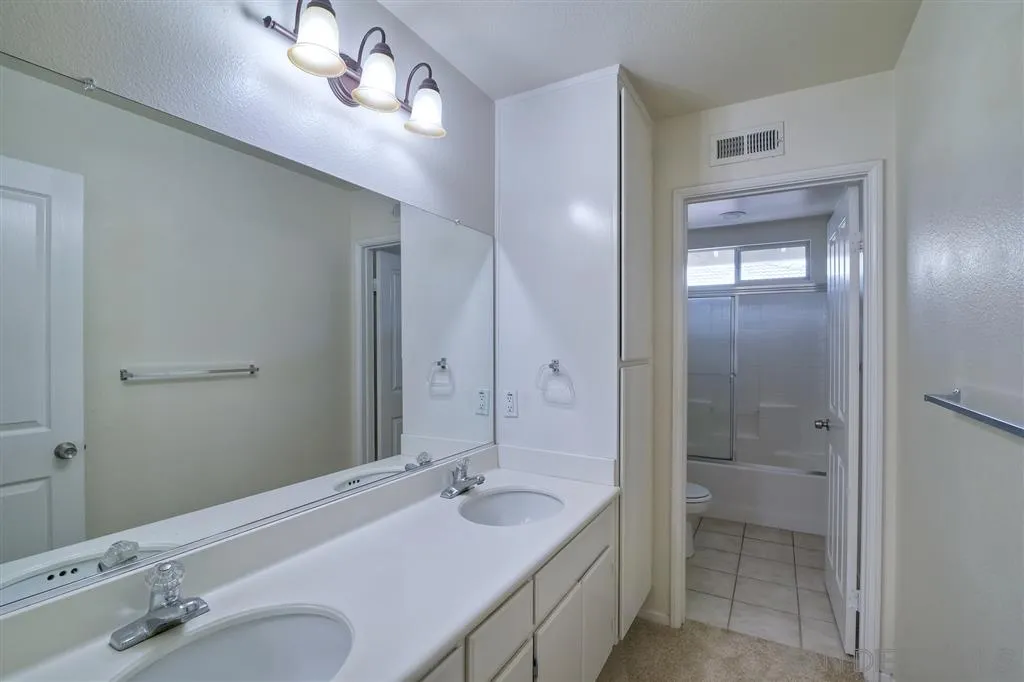 11574 Village Ridge Road San Diego, CA 92131 - Photo 18 of 25 a bathroom with a sink double vanity granite tub and shower