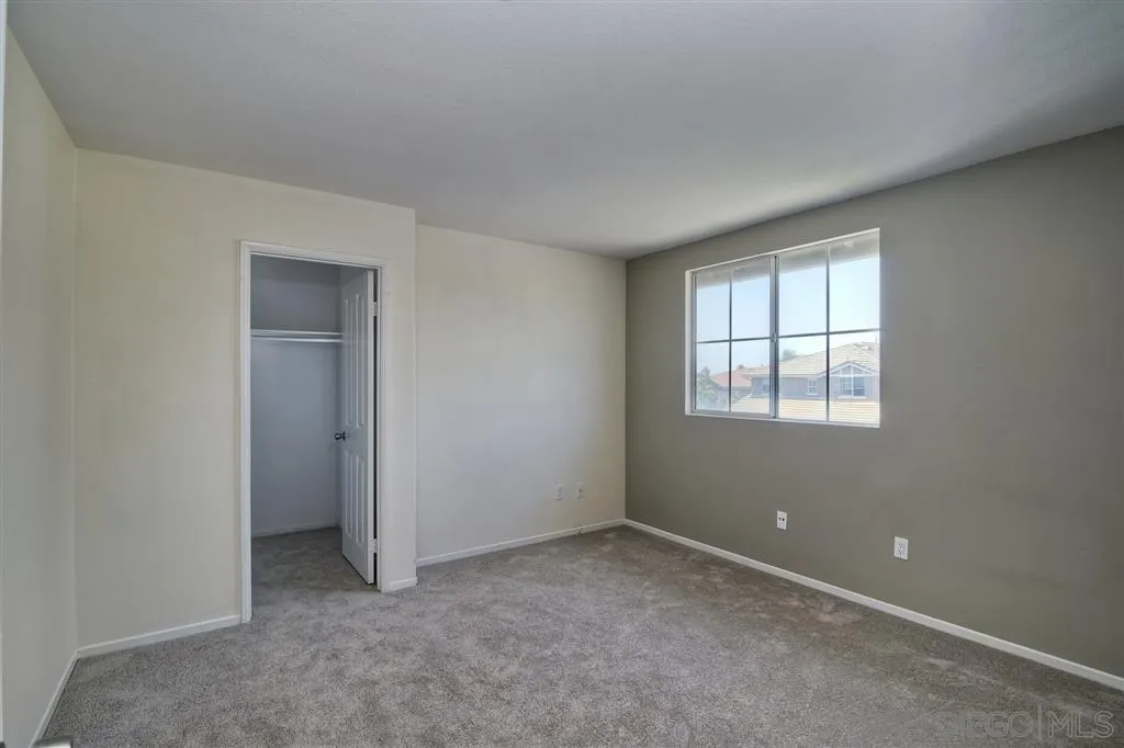 11574 Village Ridge Road San Diego, CA 92131 - Photo 19 of 25 an empty room with windows and closet