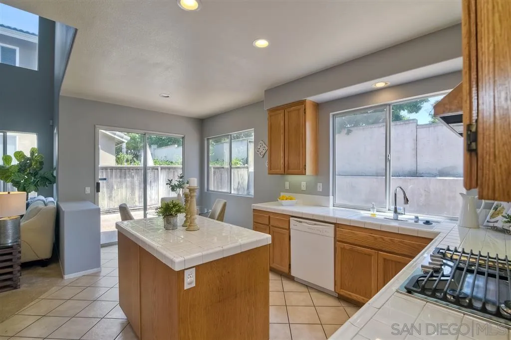 11574 Village Ridge Road San Diego, CA 92131 - Photo 6 of 25 a kitchen with a sink stove and cabinets